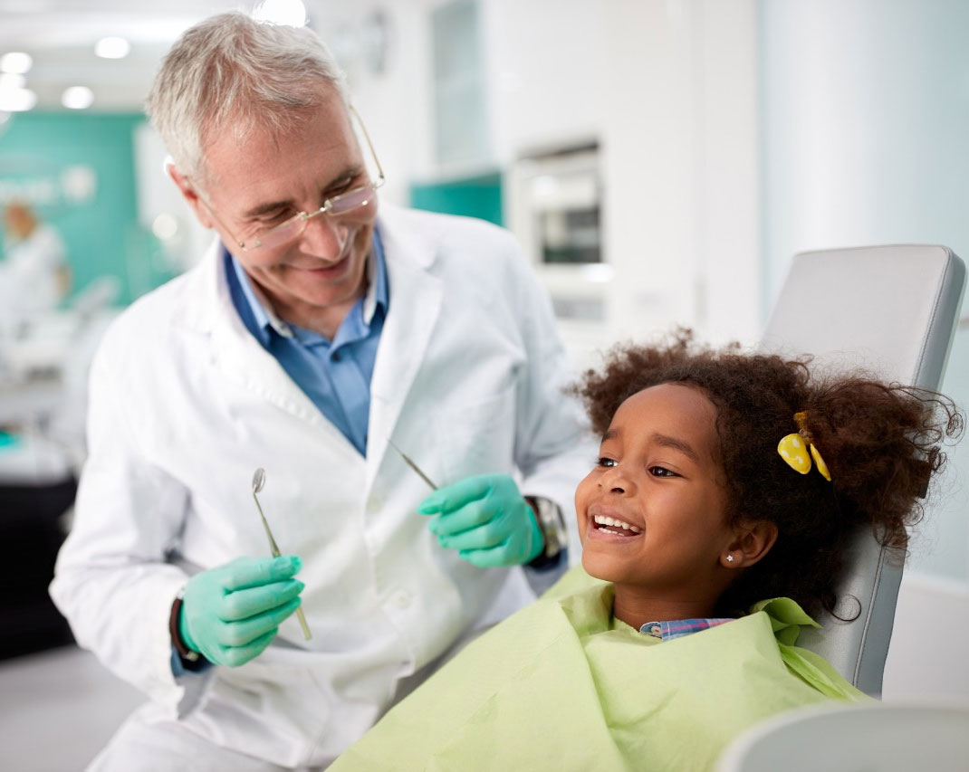 Young smiling Medicaid patient with dentist